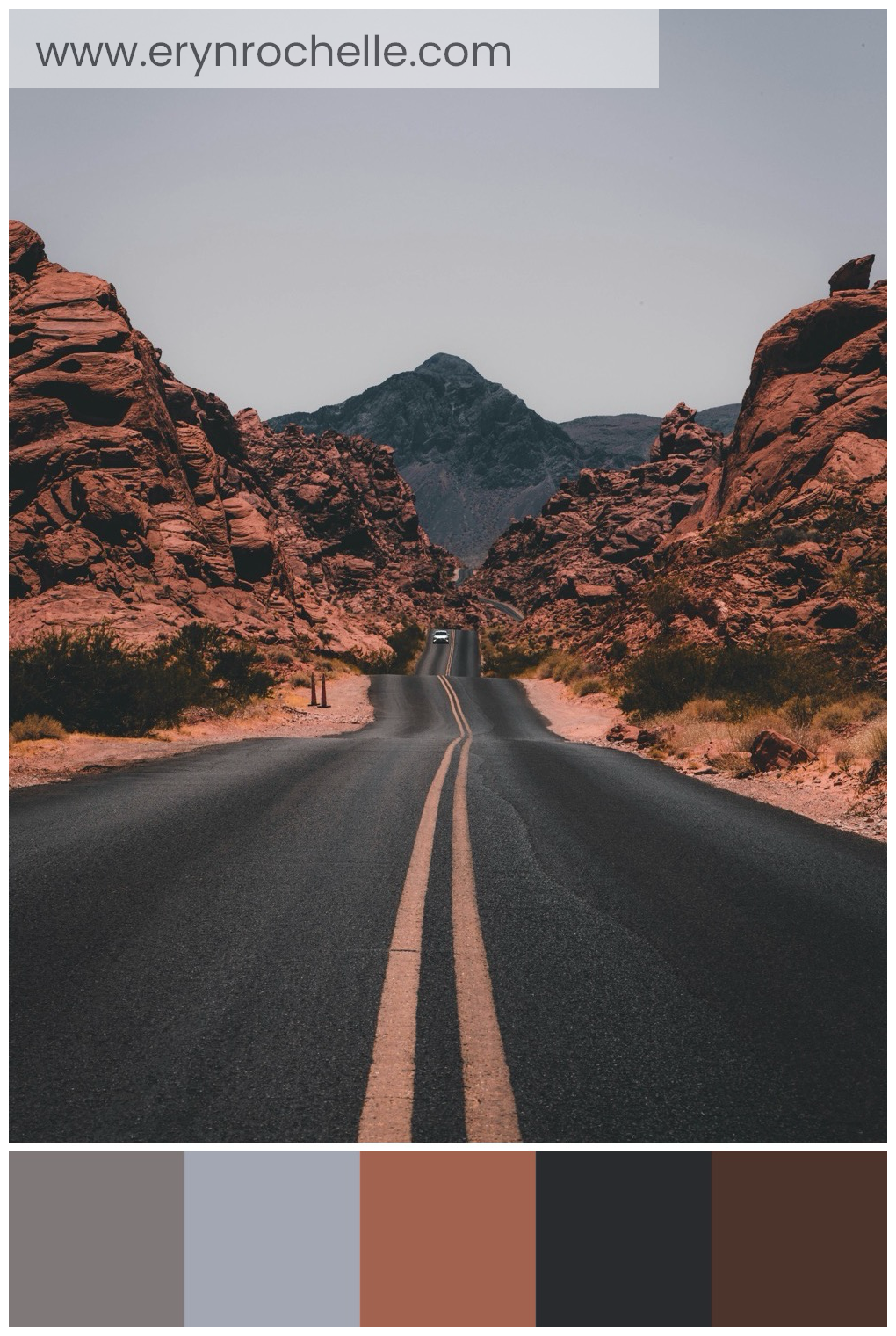 A black concrete road surrounded by brown rocks, showcasing the rugged, earthy tones of the landscape.