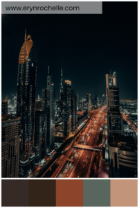 A nighttime view of high-rise buildings illuminated by city lights, featuring a color palette of deep charcoal, rich espresso, burnt sienna, urban gray, and soft peach tones.