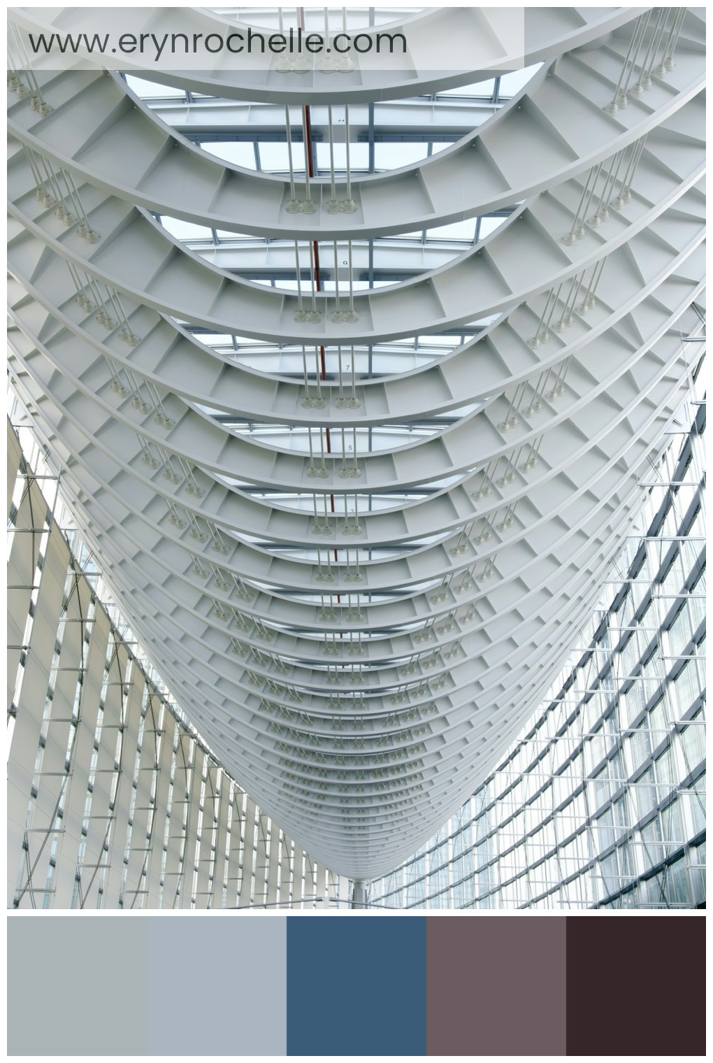 A very large building with a very long ceiling, featuring a color palette of soft silver, pale gray, steel blue, dusty mauve, and deep mahogany tones.